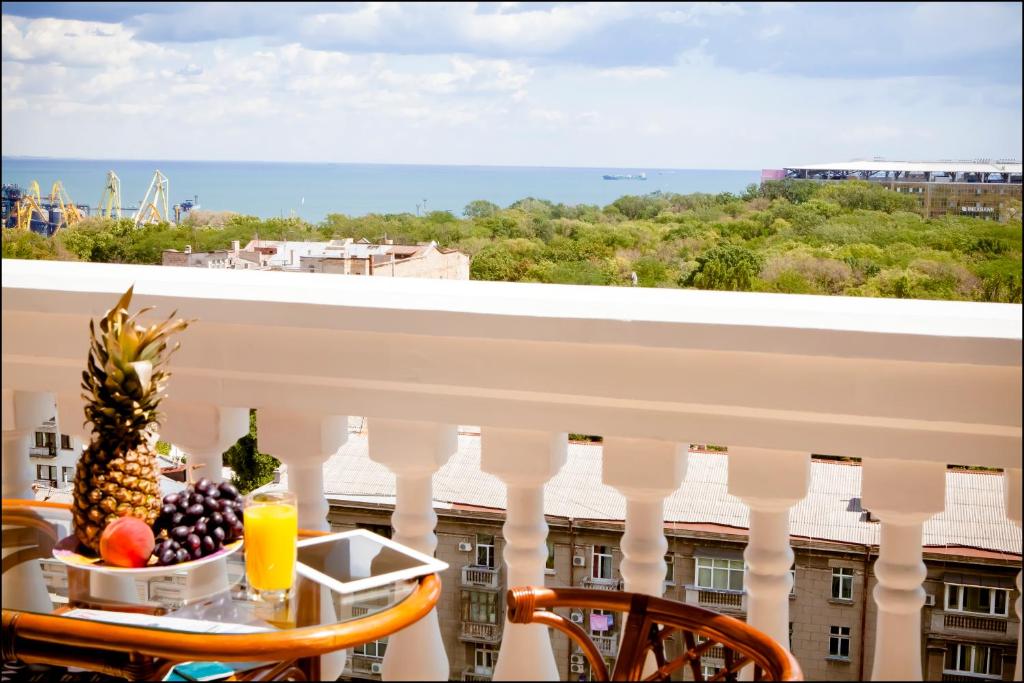 a table with a bowl of fruit on a balcony at Luxury Apartment in the City Centre in Odesa