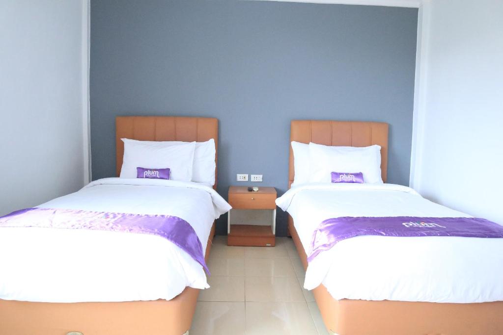 Postel nebo postele na pokoji v ubytování Plum Hotel Lading Banda Aceh