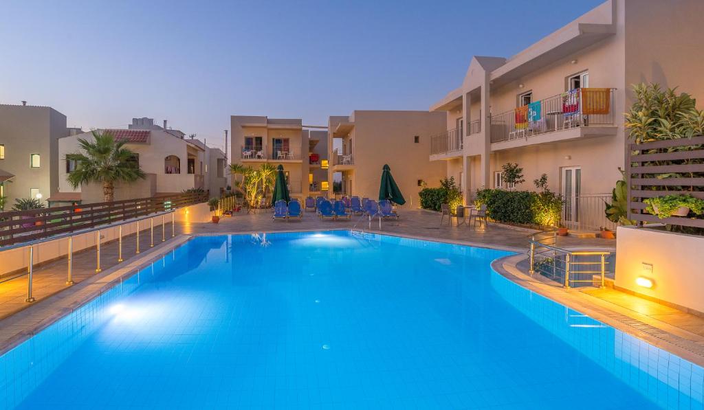 a large swimming pool in the middle of a building at Creta Verano Hotel in Malia