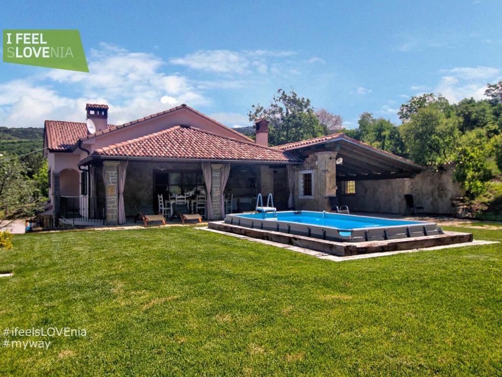 a house with a swimming pool in the yard at Apartma Rihter in Črni Kal