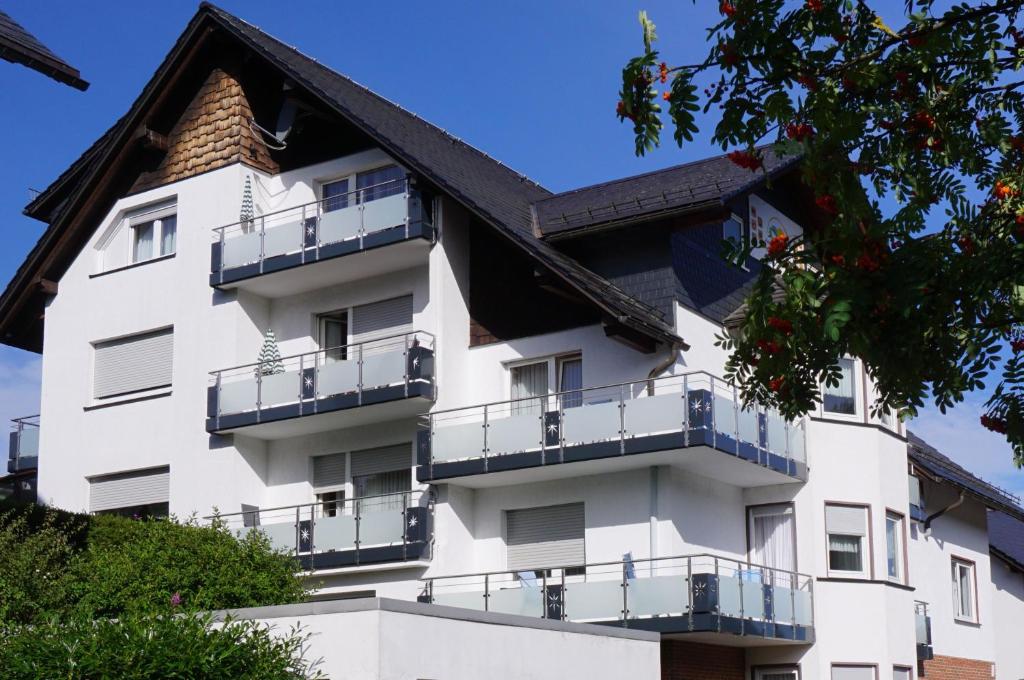 a white building with balconies on it at Aritee Apartments Sonnenschein in Willingen