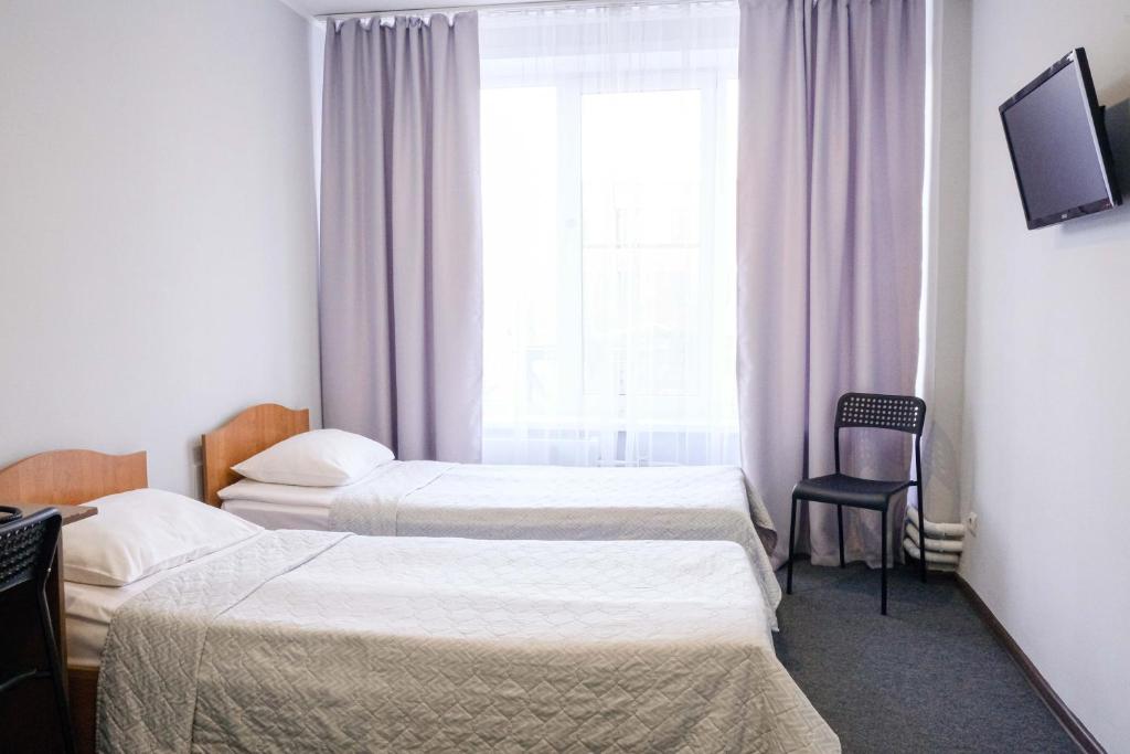Кровать или кровати в номере Протекс-Отель
