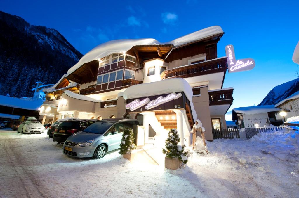 a building with a car parked in the snow at Hotel Victoria in Ischgl