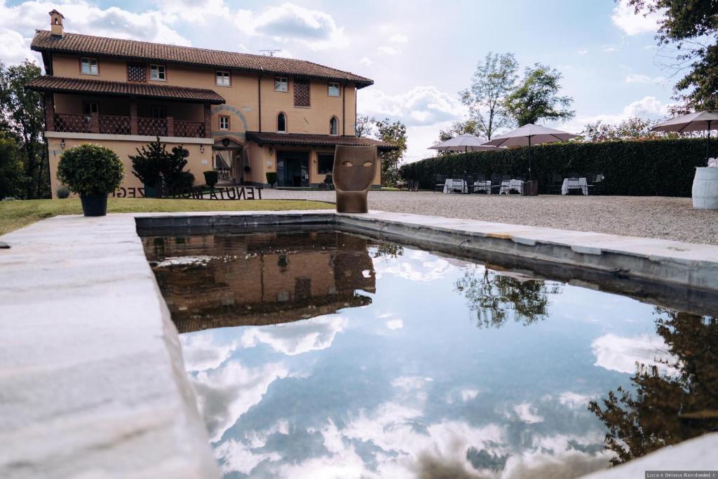 a pool of water in front of a house at Tenuta Montezeglio Country Family House in Invorio Inferiore