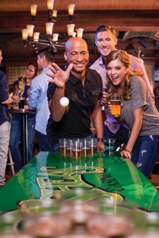 a group of people standing around a table at The LINQ Hotel and Casino in Las Vegas