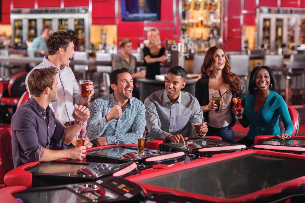 a group of people playing roulette in a casino at The LINQ Hotel and Casino in Las Vegas