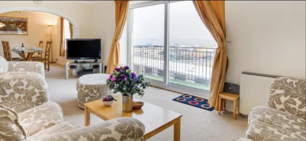 sala de estar con sillas y ventana grande en Anchor Point, en Seahouses