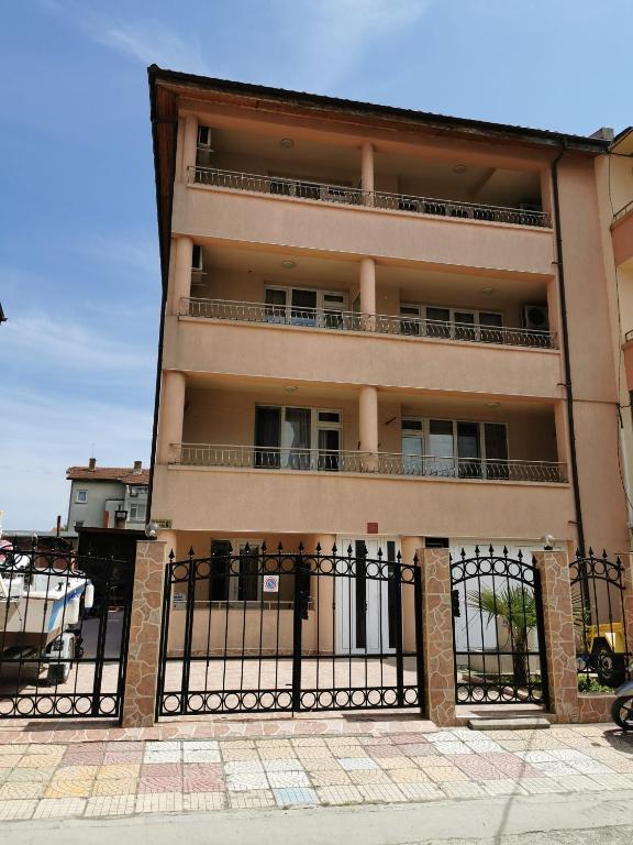 a building with a black fence in front of it at Къща за гости Aтанасов II in Primorsko