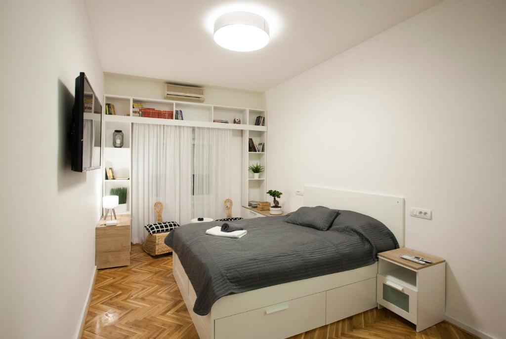 a bedroom with a bed and a television in it at Studio 10 in Belgrade