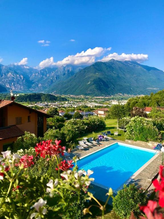 a view of a swimming pool with mountains in the background at Casa Camilla in Colico