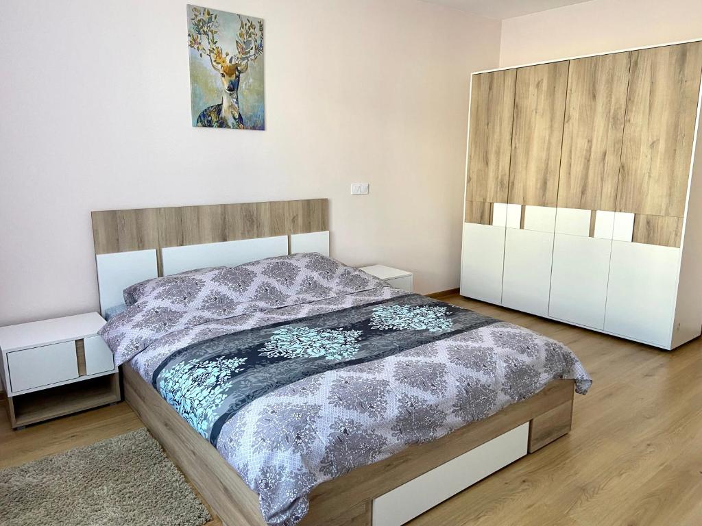 a bedroom with a bed and two night stands at Apartment in Studenets, Pamporovo in Pamporovo