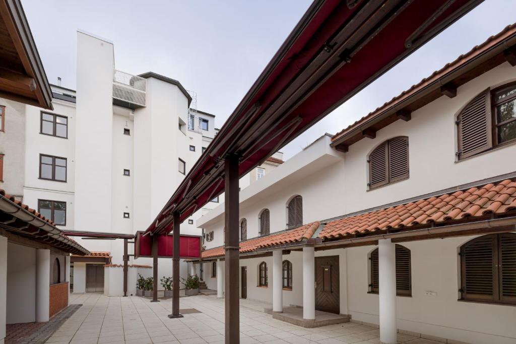 an empty courtyard of a building with white buildings at Vienna Stay Apartments Schönbrunn in Vienna