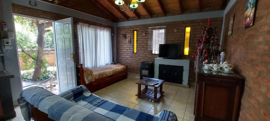 a living room with a couch and a television at Merlo2 in Merlo