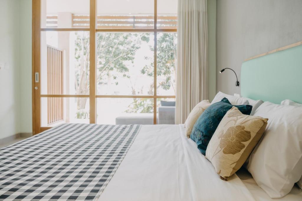 Postel nebo postele na pokoji v ubytování Wana Karsa Ubud Hotel