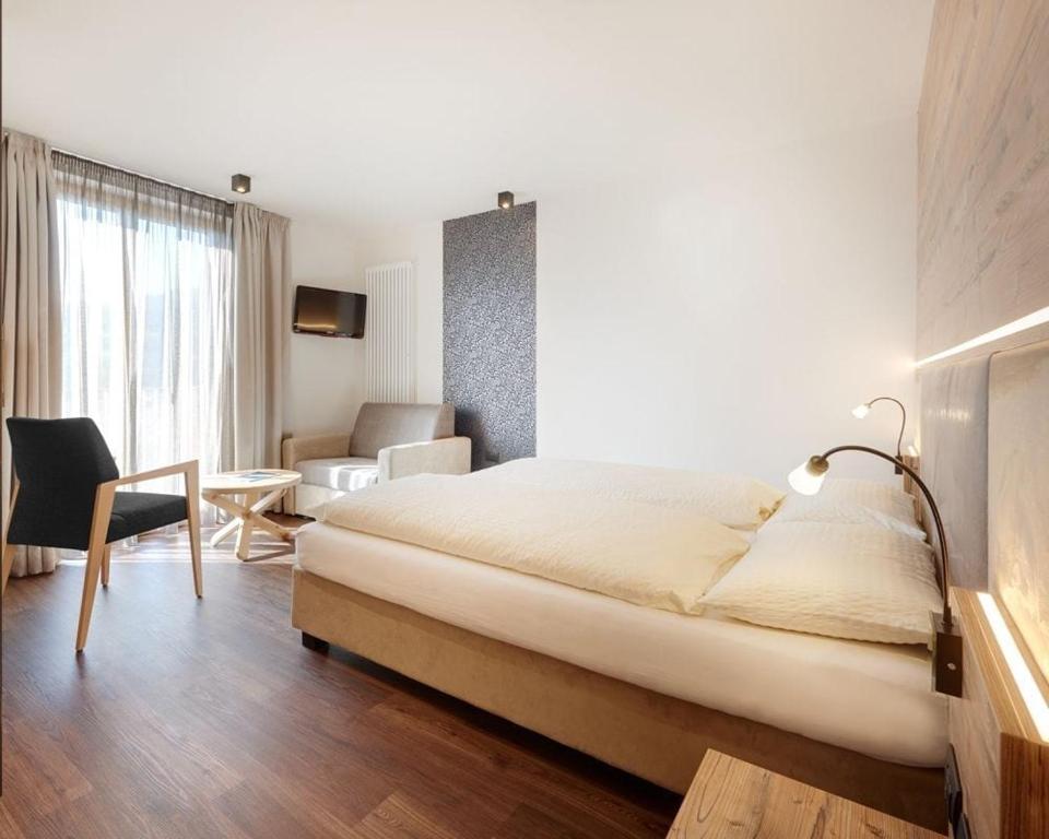 Postel nebo postele na pokoji v ubytování Hotel Al Cervo