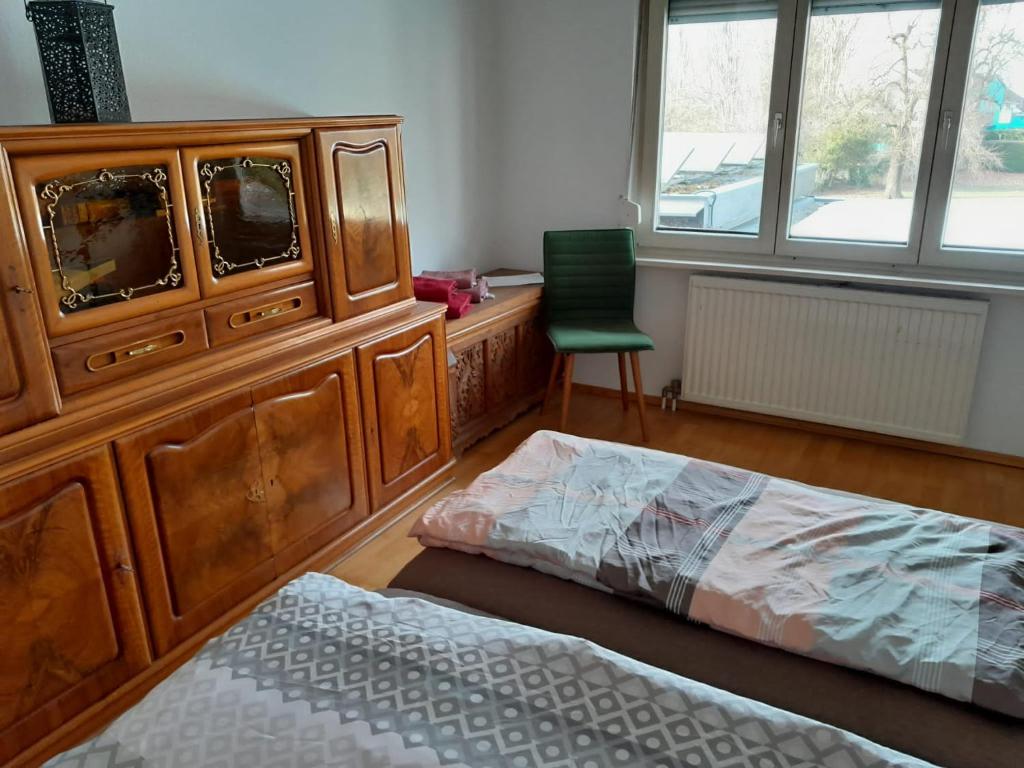 a bedroom with a large wooden dresser and a bed at Dimai House No 31 Dornbirn Messe in Dornbirn