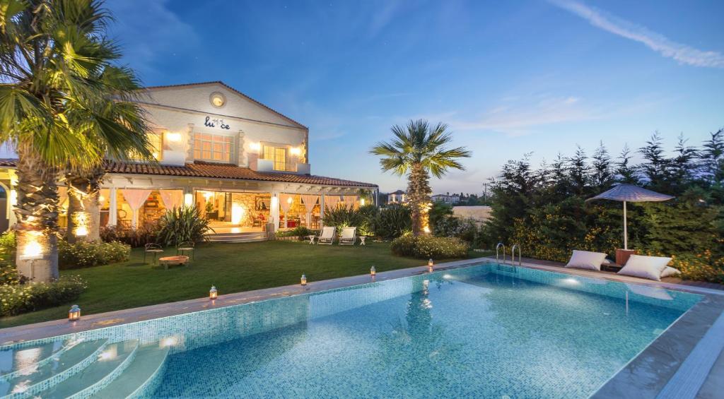 une grande piscine en face d'une maison dans l'établissement Alacati LuCe Design Hotel - Special Category, à Alaçatı