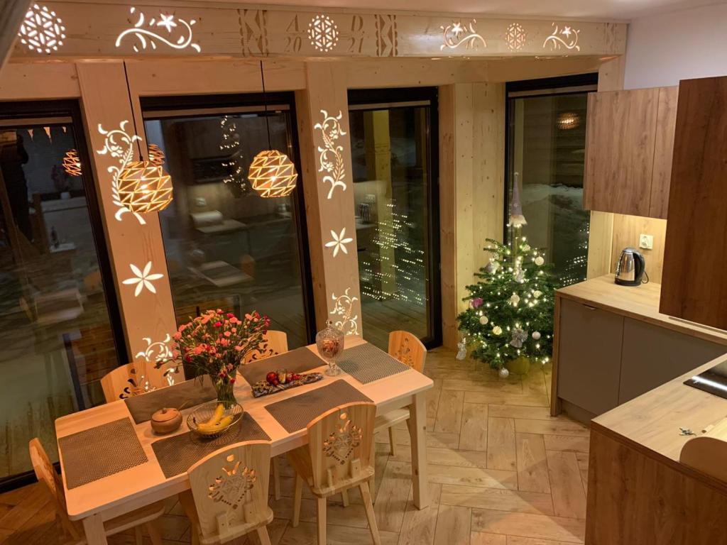 a kitchen with a table and a christmas tree at Domek Zakopiański Czar in Zakopane