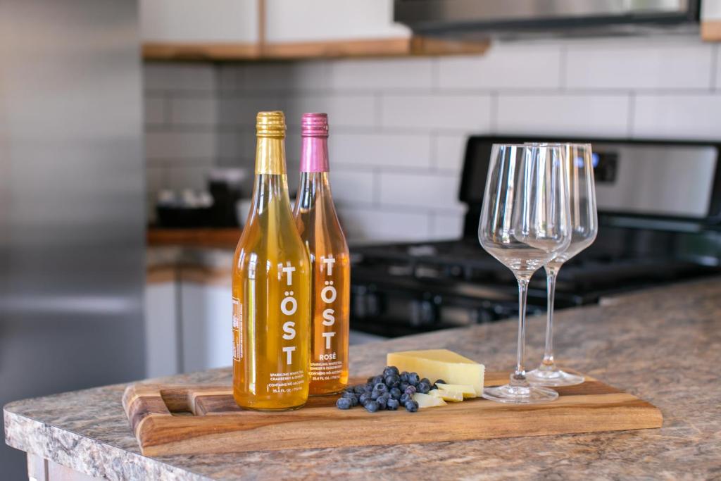 two bottles of wine on a cutting board next to a glass at Heartwell Park Beauty Long Beach in Long Beach