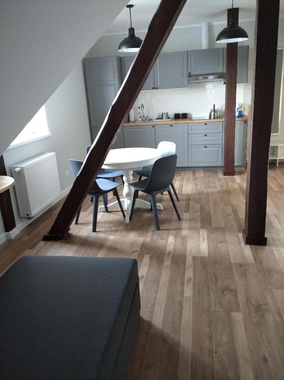 a kitchen and dining room with a table and chairs at Familijny in Toruń
