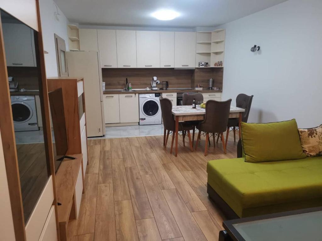 a living room and kitchen with a table and a couch at new apartment near city center with free parking in Sofia