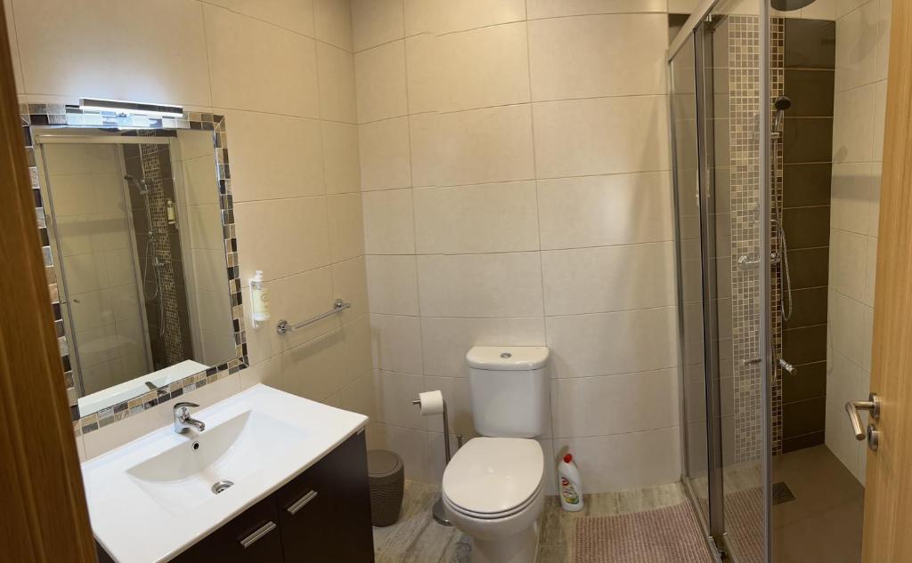 a bathroom with a toilet and a sink and a shower at Time Holiday´s House in Olhão