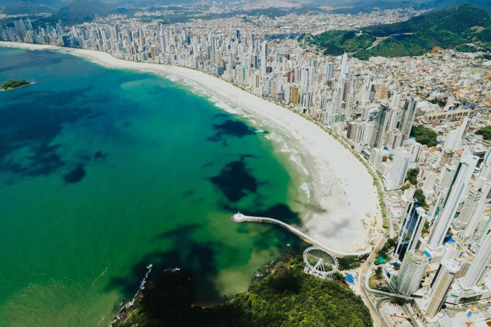 an aerial view of a city and a beach at Apartamento Quadra Mar Balneário Camboriú in Balneário Camboriú