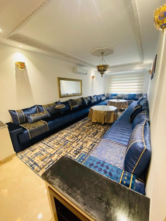 a living room with a blue couch and a table at welcom to castilla in Tangier