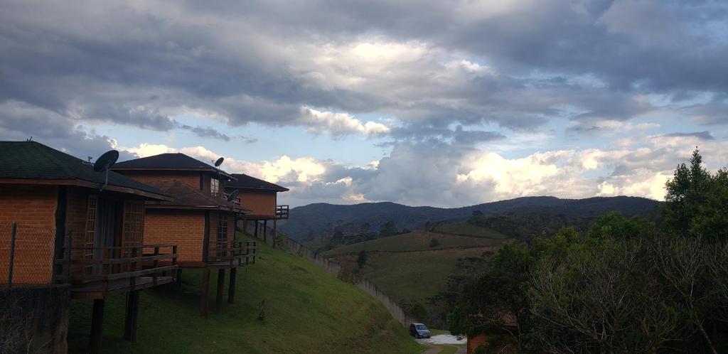 a house on the side of a hill with a view at Cabanas Mountain in Campos do Jordão