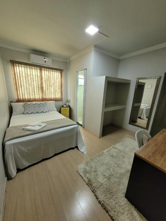 Postel nebo postele na pokoji v ubytování Hotel Hiperion Maringá