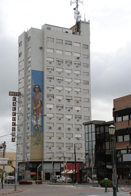 a white building with a mural on the side of it at Calfucura Apart Hotel in Santa Rosa