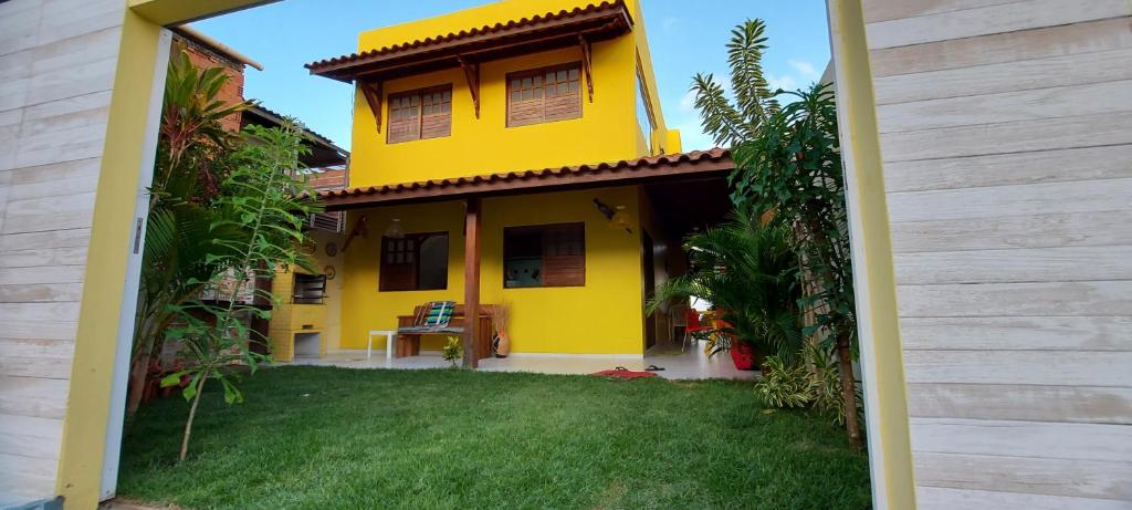 a yellow house with a yard in front of it at Casa fulô dos Milagres in São Miguel dos Milagres