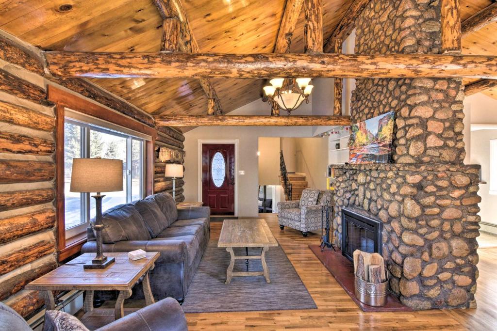 a living room with a couch and a fireplace at Downtown Buena Vista Cabin with Patio and Grill! in Buena Vista