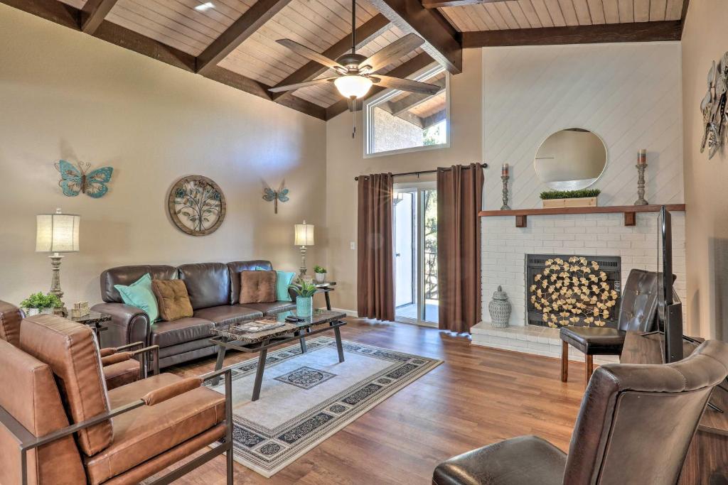 a living room with a couch and a fireplace at Condo with Mtn Views, Balcony and Hot Tub Access! in Sedona