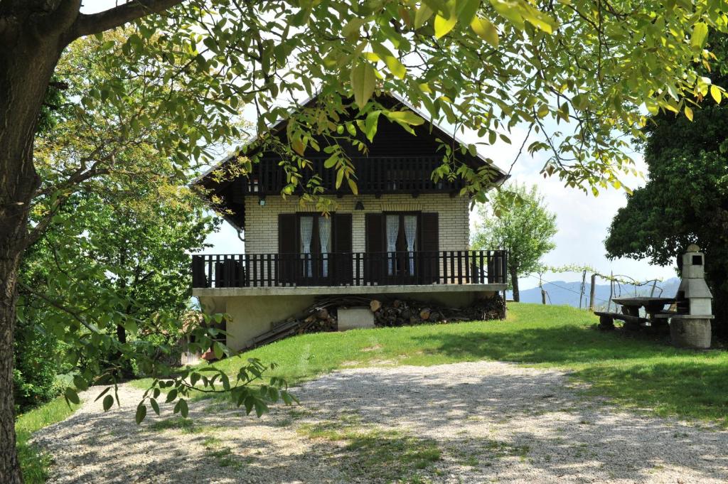 a small house with a balcony on a hill at Vineyard Cottage Vrbek in Roginska Gorca