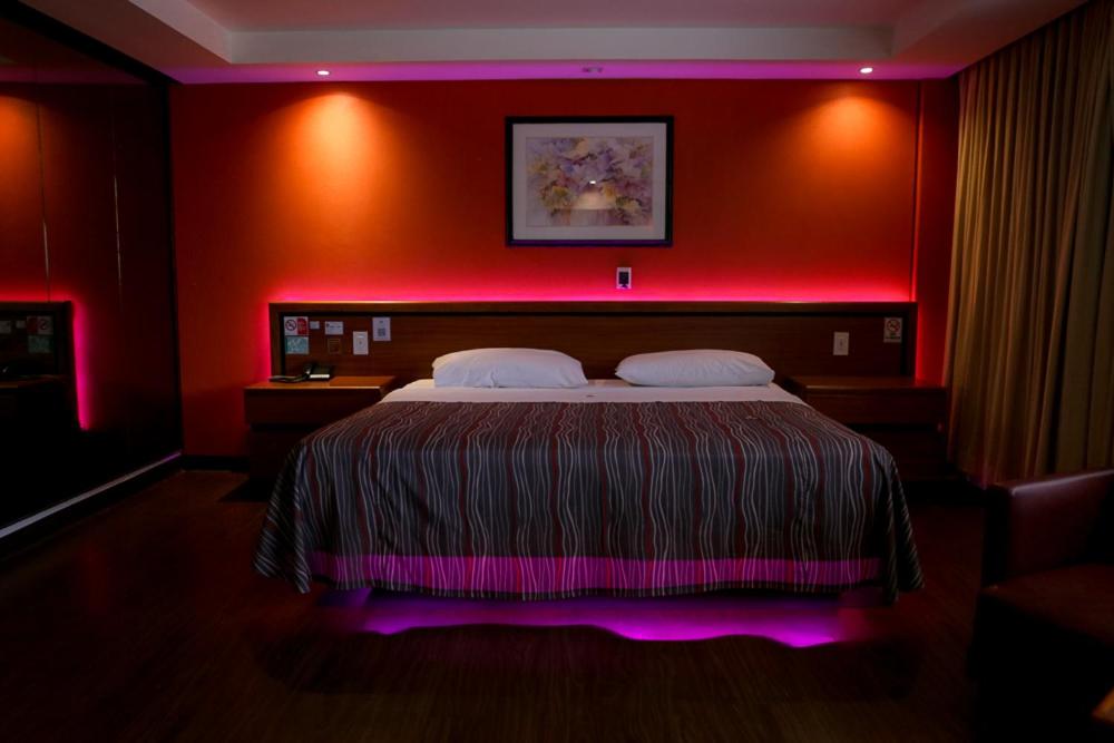 1 dormitorio con 1 cama con iluminación rosa en Hotel Montreal en Ciudad de México
