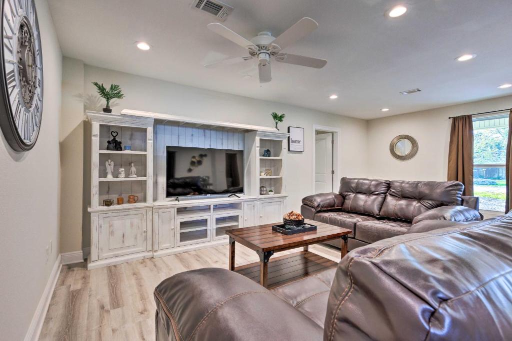 a living room with a couch and a tv at Spacious Gulfport Home with Yard 1 Mi to Beach in Gulfport