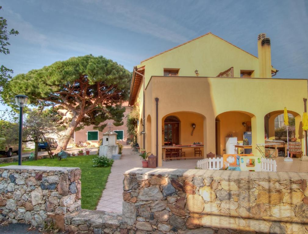 a house with a stone wall in front of it at Agriturismo Ca' Di Trincia in Pietra Ligure