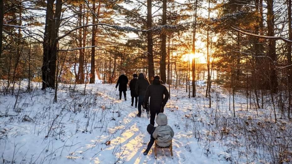 a group of people walking down a snow covered trail at Slow life nad jeziorem in Łukta