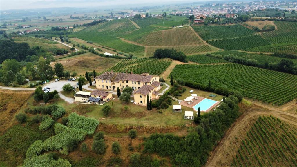 an aerial view of a house in a vineyard at Agriturismo Musignano in Cerreto Guidi