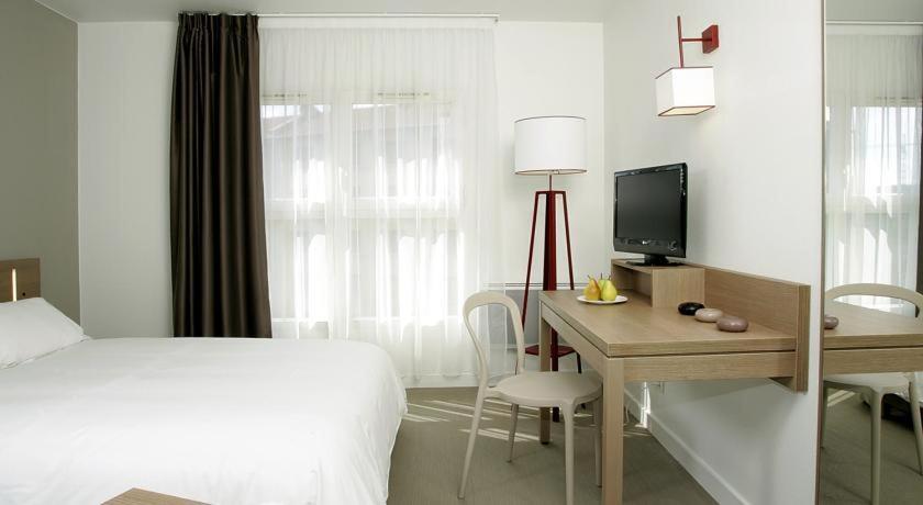 Postel nebo postele na pokoji v ubytování Terres de France - Appart'Hotel Quimper Bretagne