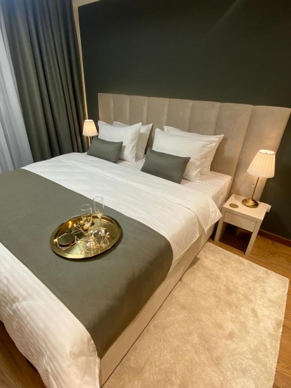 a bedroom with a large bed with a tray on it at BW Sky View Belgrade Waterfront in Belgrade
