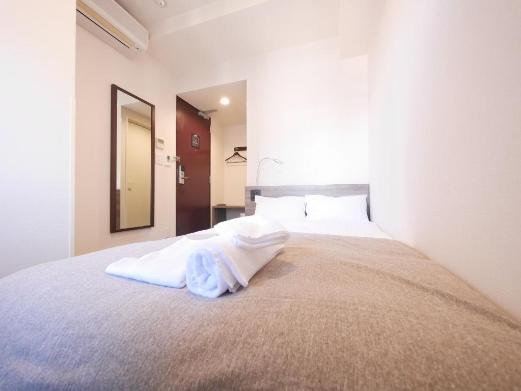 Postel nebo postele na pokoji v ubytování Hotel Comfybed Ginza