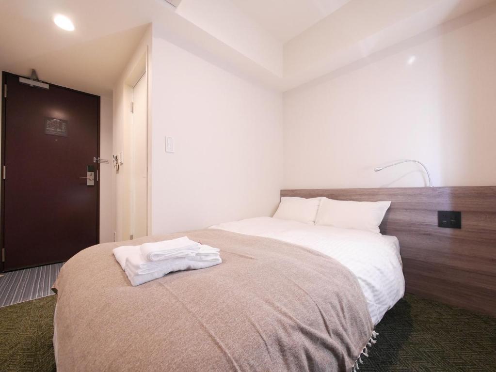 Postel nebo postele na pokoji v ubytování Hotel Comfybed Ginza