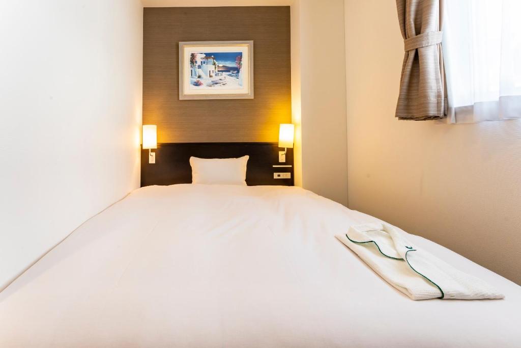 Postel nebo postele na pokoji v ubytování CVS Bay Hotel