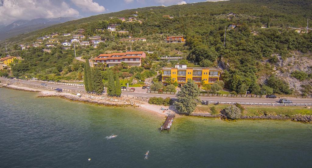 an aerial view of a house on a hill next to the water at Residence Castelli in Brenzone sul Garda