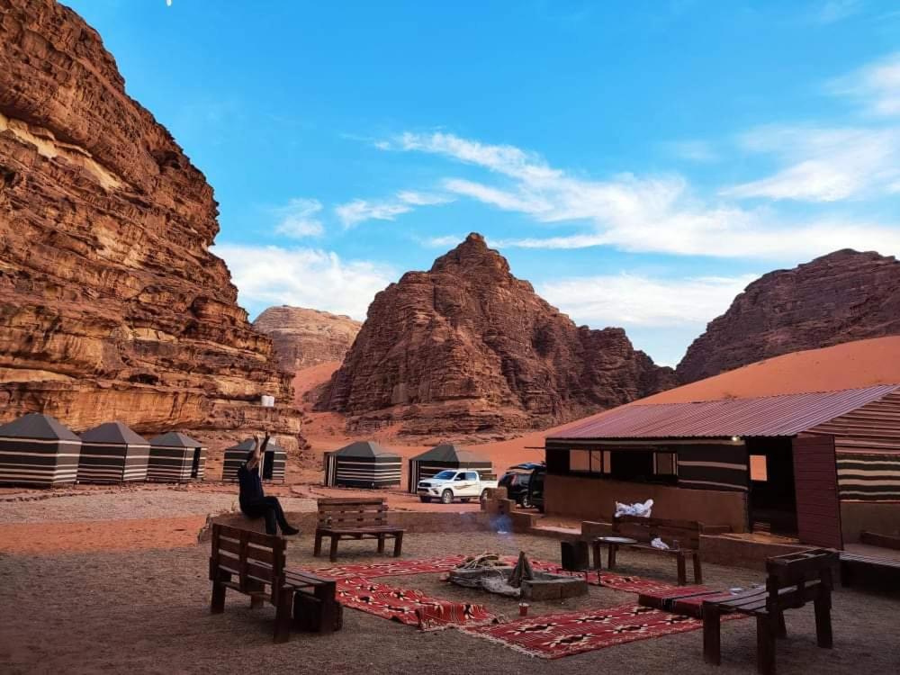 a group of tents in the desert with mountains at Wadi Rum White Mountain Camp in Wadi Rum