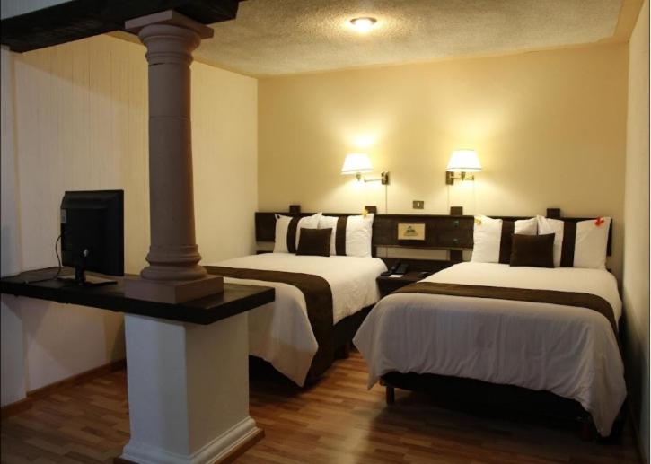 Postel nebo postele na pokoji v ubytování Hotel Misión Xalapa