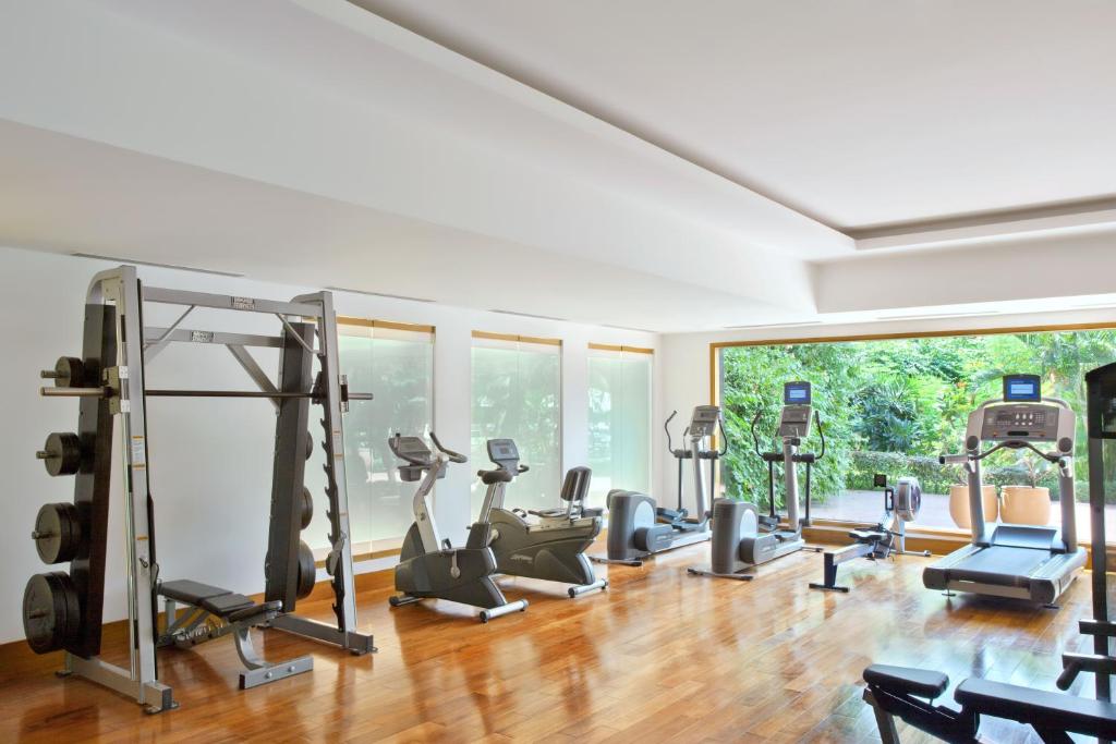 a gym with treadmills and exercise equipment in a room at Trident Chennai in Chennai