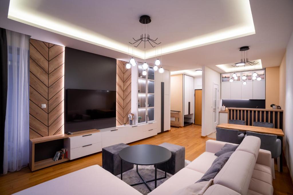 a living room with a couch and a tv at Apartman G8 Deluxe in Pale